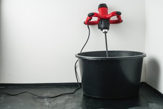 handheld electric concrete mixer on construction site photo