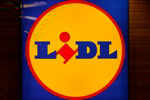 Illuminated Lidl logo inside store with wooden wall panels. German global discount supermarket chain. Copenhagen, Denmark - June 26, 2024 photo