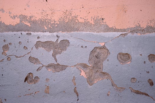 Weathered wall with peeling paint in pastel pink and gray. Ideal for backgrounds, urban photography, grunge textures, vintage aesthetics, creative design elements. Copy space photo