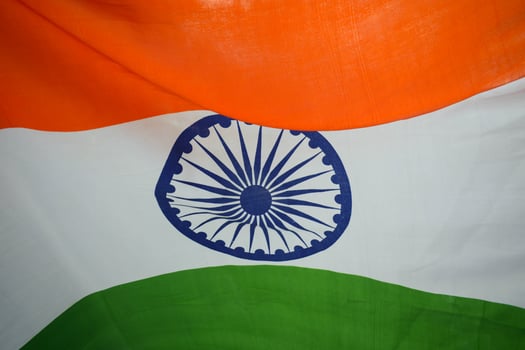 Soft watercolor strokes blending saffron, white, and green with an Ashoka Chakra outline photo