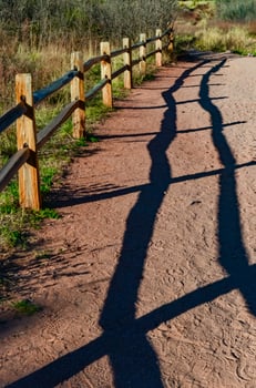 A wooden fence with a shadow from the sun, Garden of the Gods, US photo