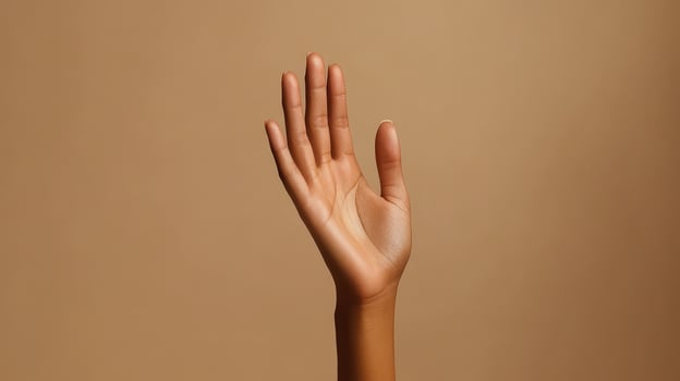 A Close-Up View of an Open Hand Against a Light Brown Background photo
