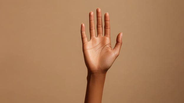 A close-up of a person's open palm with fingers extended photo