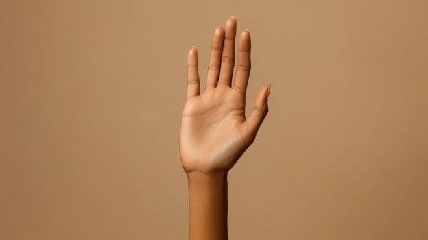 Open Hand with Spread Fingers Against a Tan Background photo