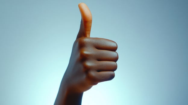 Close-up of a person's hand giving a thumbs up gesture photo