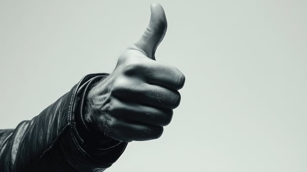 Close-up of a Man's Hand Giving a Thumbs Up in Black and White photo