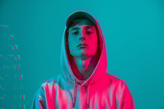 Chic Fashion Male Model in Neon pink Hoodie with Neon Teal Background Trendy Urban portrait Featuring Contemporary Fashion photo