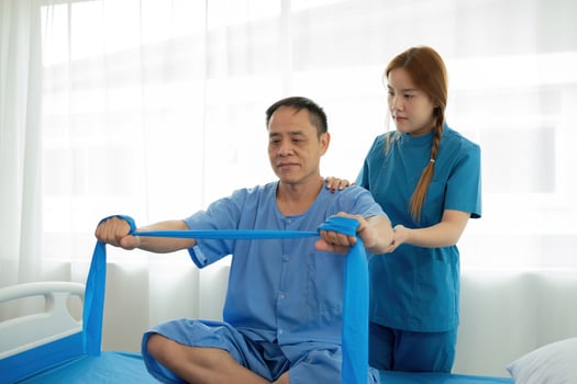 Elderly Patient Receiving Physical Therapy from Young Female Therapist in Modern Medical Facility photo