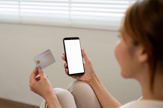 Woman Holding Credit Card Shopping Online with Smartphone at Home - Modern E-commerce and Digital Payment Concept photo