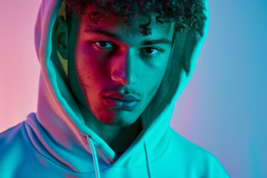 Trendy Fashion Male Model in Mint Green Hoodie with Neon Blue Details Males portrait Featuring Chic Appearance and Stylish Clothing Set Against a Modern Background photo