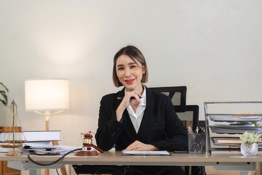 Professional Female Lawyer Reviewing Legal Documents in Modern Office Setting for Lawsuit Case photo