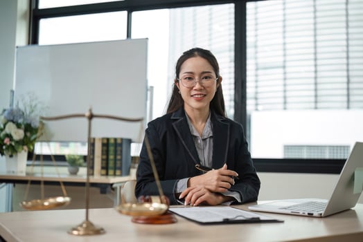 Professional Female Lawyer Reviewing Legal Documents in Modern Office Setting for Lawsuit Preparation photo
