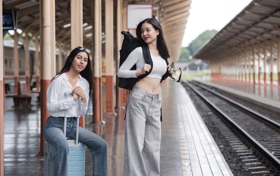 Young Lesbian Couple Waiting for Train at Train Station, Embracing Adventure and Travel Together photo