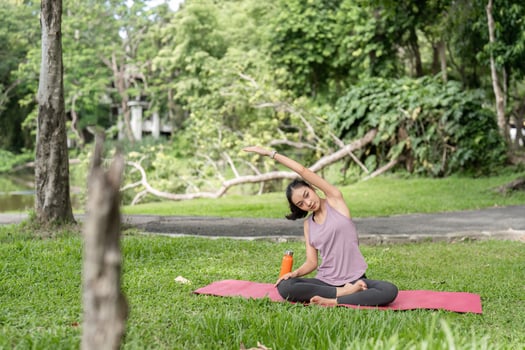 Young Healthy Woman Practicing Yoga Outdoors in a Park, Embracing Nature and Wellness photo