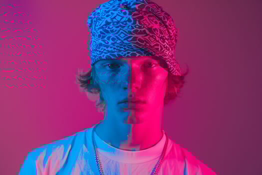 Handsome Fashion Male Model in Neon Aqua Bandana with Neon pink Background Showcasing Trendy Males portrait Fashion photo