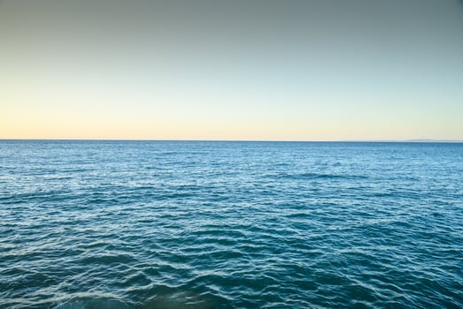 Blue sea water surface on sky photo