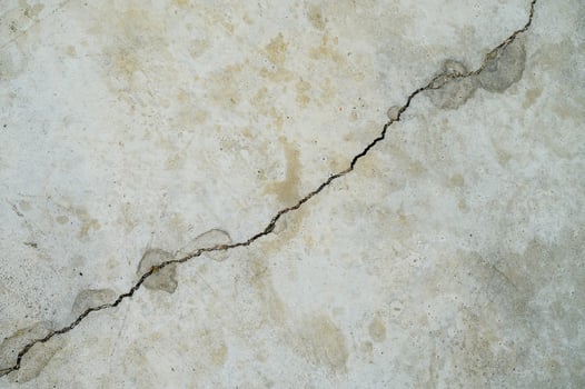 Cracked concrete wall in gray photo