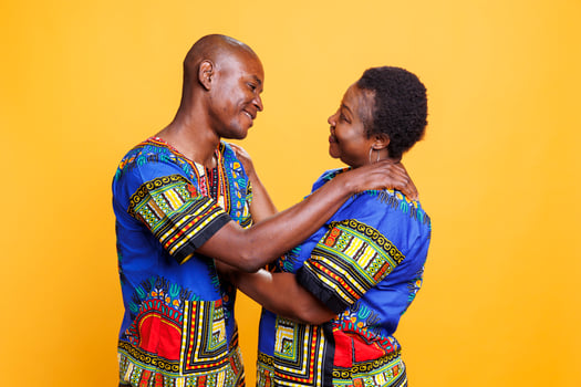 Smiling african american romantic couple looking at each other with love and hugging. Man and woman spouse standing together and embracing while showing affection and happiness photo