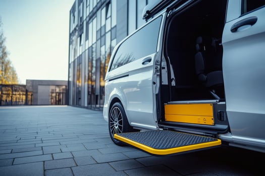 A contemporary minivan equipped with a modern wheelchair accessible ramp demonstrates a thoughtfully extended ramp, specifically crafted for easy access, all set against a bustling urban backdrop photo