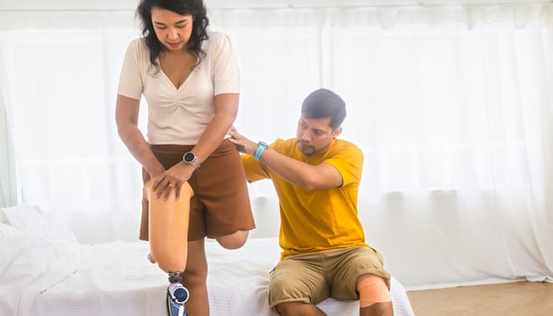 man and a woman are sitting on a bed photo