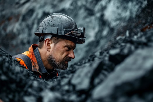 Hardworking Miner in Coal Mine with Protective Gear and Helmet photo