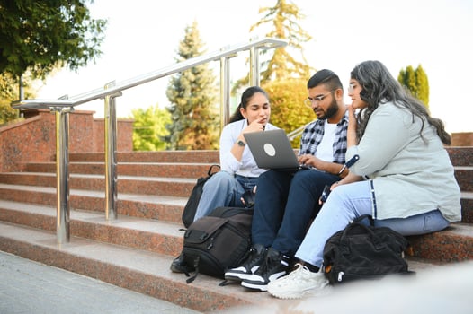 group of young students checking exam results or waiting for project approval on laptop at collage campus photo