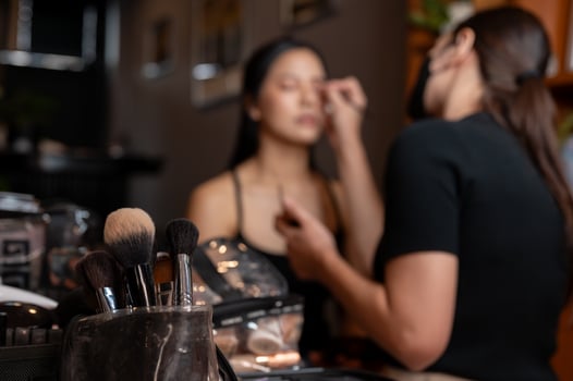 In a makeup studio, a set of makeup brushes in a bag on the table is in selective focus. photo