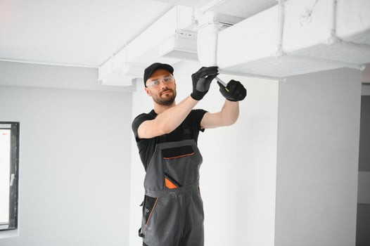 hvac services, worker install ducted pipe system for ventilation and air conditioning in house photo