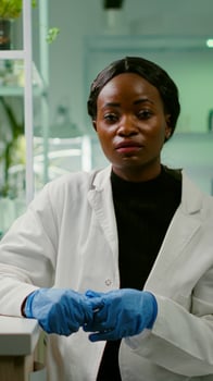 Pov of botanist researcher woman explaining botany experiment during online videocall meeting while sitting in pharmaceutical lab. Specialists team researching genetic mutation developing dna test photo