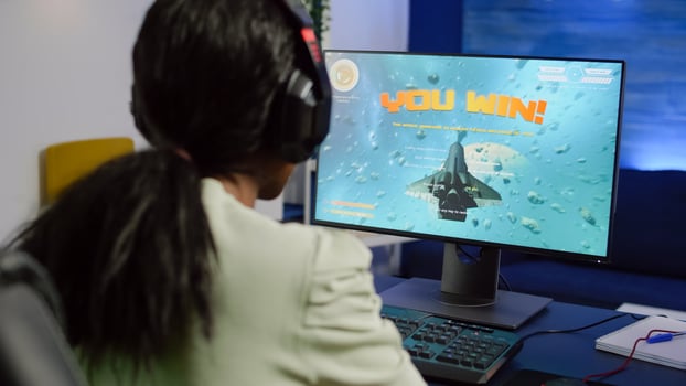 African streamer woman winning space shooter game during esport tournament playing with joystick. Pro gamer using wireless controller, professional mouse and headset at night in streaming home photo
