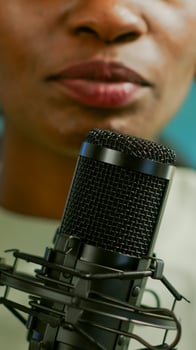 Close up of famous woman recording a vlog for subscribers using podcast microphone for vlogging. On-air online production internet broadcast show host streaming live content for social media photo