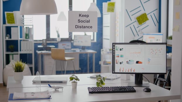 Financial business graphs in empty office with nobody in it, keep social distance signs on the wall. Plastic separators during coronavirus covid 19 economy health crisis photo