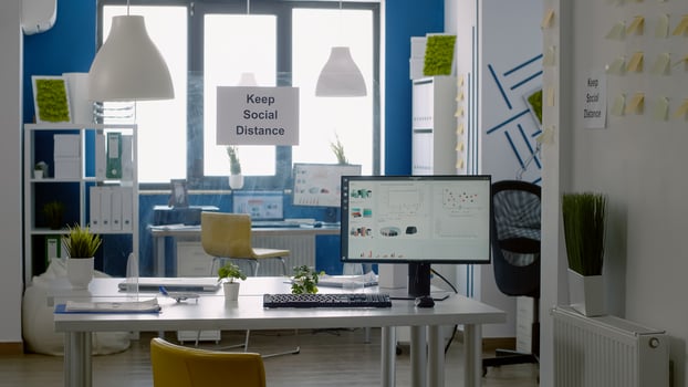 Keep social distance sign in empty business office with nobody in it. Working corporate during global pandemic with safety measurement against covid 19 photo
