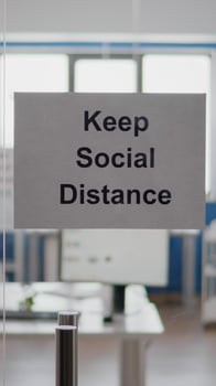 Business glass interior office with keep social distance sign on the wall. Modern office space with nobody in it during global pandemic, coronavirus crisis photo