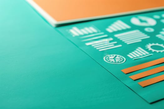A collection of icons and symbols representing CRM concepts arranged neatly on a teal backdrop, showcasing artistic design elements. photo