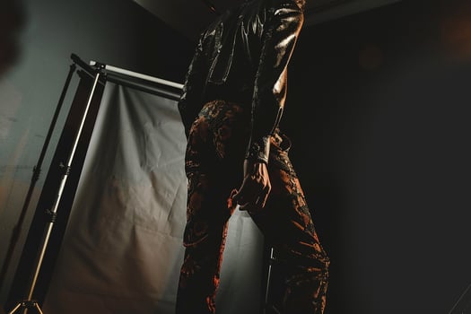 Stylish male fashion model in Couture pants with Black background featuring a chic lifestyle portrait of modern Males attire photo
