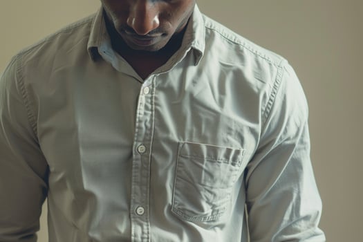 Trendy male fashion model in a casual button down shirt with a soft cream background showcasing modern Males portrait fashion and lifestyle photo