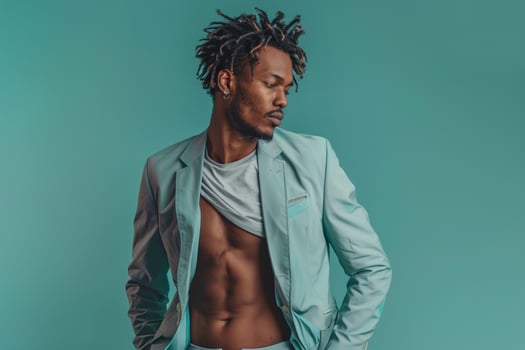 Fashionable male model in a chic blazer against a mint background presenting an elegant fashion portrait ideal for contemporary style inspiration photo
