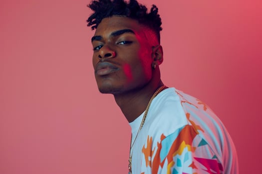 Trendy male fashion model in vintage graphic tee coral pink background showcasing a stylish and contemporary lifestyle portrait with a focus on current fashion styles photo