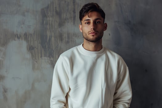 Fashionable male fashion model in luxe sweatshirtmale dress shot withcostume gray Males background Lifestyle portrait highlightingstyle trends photo
