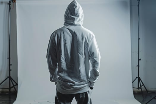 Dove Gray Background with Hoodie Clad Male Lifestyle portrait Highlighting Relaxed Costume Fashion and Trendy Style photo