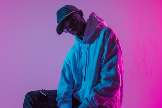Streetwear Hoodie Clad Male with Neon purple Background Lifestyle portrait Highlighting Trendy Fashion and Modern Style photo