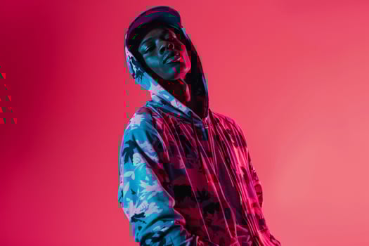printed Zip Up Hoodie Clad Male with Neon pink Background Fashion portrait emphasizing Contemporary Trends and Style photo