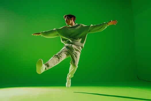 Sweater Clad Male Fashion portrait with Bright Green Background Demonstrating a Casual and Trendy Fashion Style photo