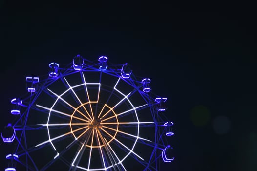 Ferris wheel with blue lights against the night sky. Attractions in the park. photo