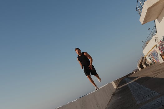Confident young man in sports clothing enjoying his everyday morning jog outdoors photo