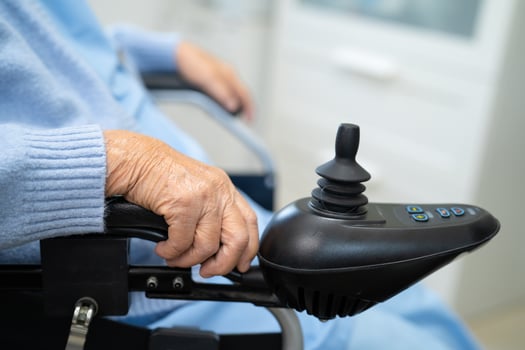 Asian senior woman patient on electric wheelchair with remote control at hospital, healthy strong medical concept. photo