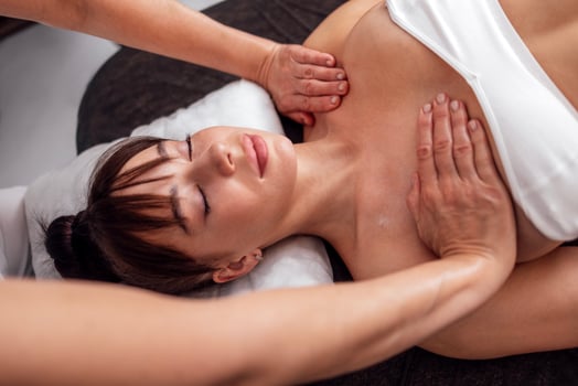 Close up of portrait of young beautiful woman receiving neck and shoulder massage. photo
