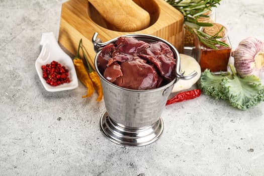 Raw uncooked chicken liver in the bowl photo