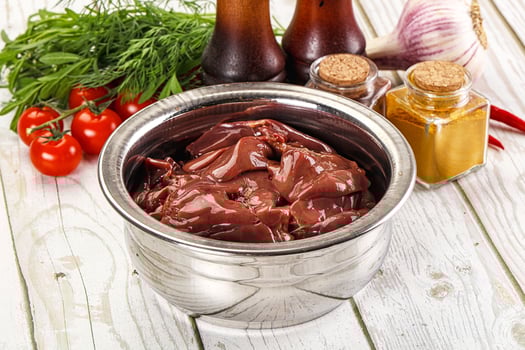 Raw chicken liver uncooked in the bowl photo